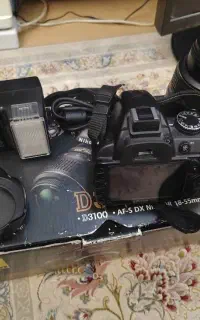 دوربین عکاسی نیکون D3100 به همراه پایه دوربین