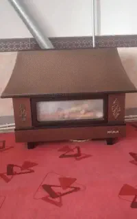 بخاری گازی شومینه نیک کالا و یک دست مبل راحتی