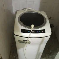 ماشین لباسشویی درب بالا و میز تی وی