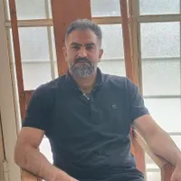 کیف پول قهوه ای رنگ با مدارک به اسم رضا محمدزاده
