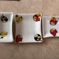 ظرف غذا کودک و یک پیراهن پسرانه