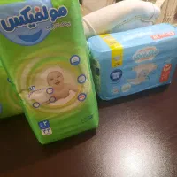 پوشک مولفیکس و مای بی بی و قوطی خالی شیر خشک