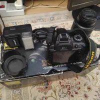 دوربین عکاسی نیکون D3100 به همراه پایه دوربین