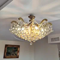 لوستر ۱۵ شاخه برنز با کریستال های شامپاینی