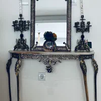 اینه و کنسول با دوتا شمعدان و ظرف دو طبقه شیرینی