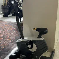 دوچرخه ثابت به همرا دو دمبل ۱۰کیلوگرمی