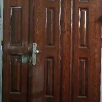 در چوبی ورودی با چارچوب فلزی سالم