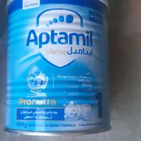 تعدادی قوطی شیر خشک با پیمانه تهران پارس