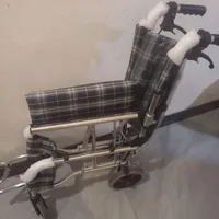 یک عدد ویلچر مسافرتی