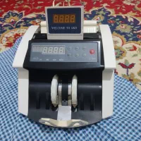 یک عدد دستگاه پول شمار و یک عدد تلفن فکس