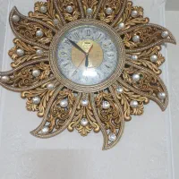 ساعت دیواری طلایی ومشکی