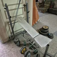 صفحه، میله هالتر و دمبل به همراه میز چند کاره