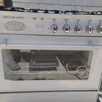 اجاق گاز رویه استیل بدنه لعاب در حد نو