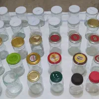 تعدادی بانکه ی شیشه ای و دبه ی پلاستیکی