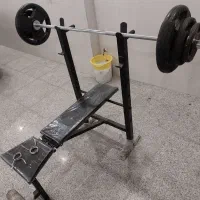دستگاه بدنسازی به همراه میله هالتر و وزنه