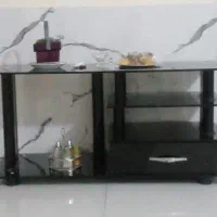 میز تلویزیون شیشه ای  بدنه الومینیم در حد نو