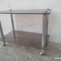 میز شیشه ای با پایه استیل چرخ دار