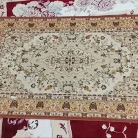 تعدادی فرش و گلیم و میز غذا خوری