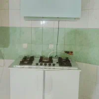 هود سفید گاز صفحه ای شیشه ای با کابینت ام دی اف